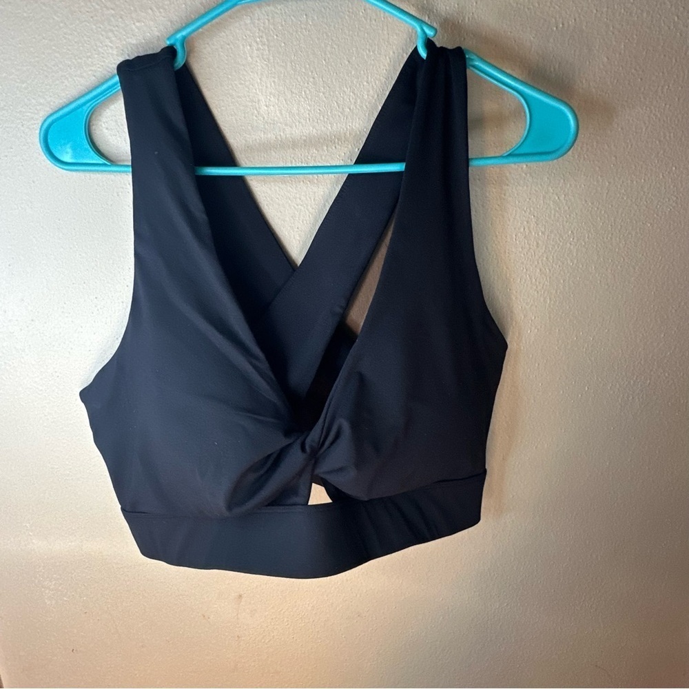 Womens Fabletics black crisscross sports bra. No size tag. Measurements in pics.